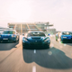A Porsche, Rimac and Bugatti driving down a road